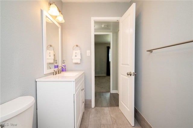 117 N Navarre Ave, Youngstown, OH 44515 - half bathroom with vanity, toilet, and wood finished floors