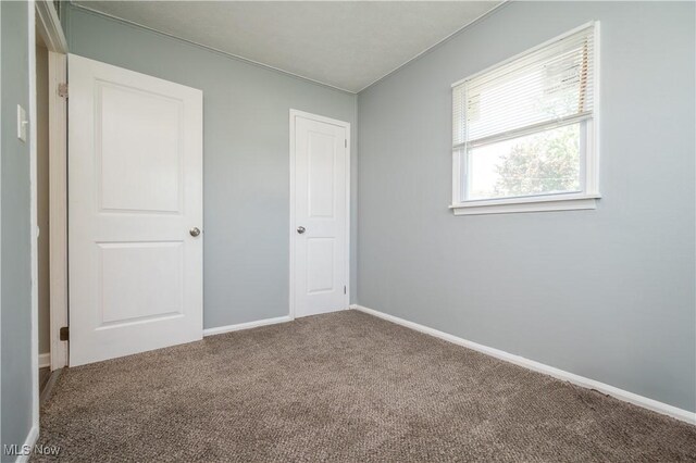 117 N Navarre Ave, Youngstown, OH 44515 - unfurnished bedroom with carpet flooring and baseboards