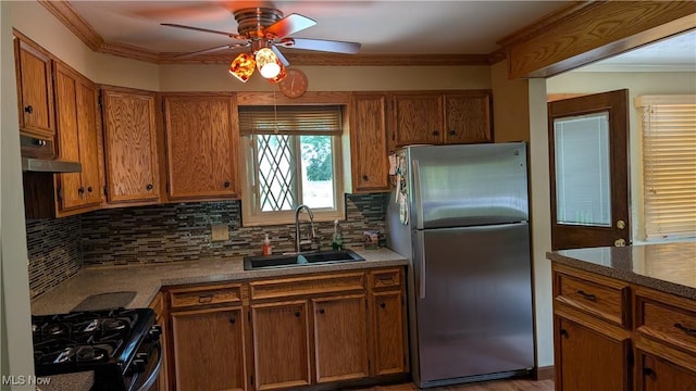 2615 Orchard Park St NW, Canton, OH 44718 - kitchen with freestanding refrigerator, a sink, gas range oven, decorative backsplash, and ornamental molding