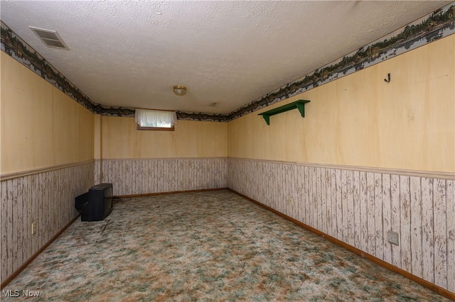 5286 Egypt Rd, Smithville, OH 44677 - basement with a textured ceiling, wainscoting, carpet flooring, wood walls, and wallpapered walls