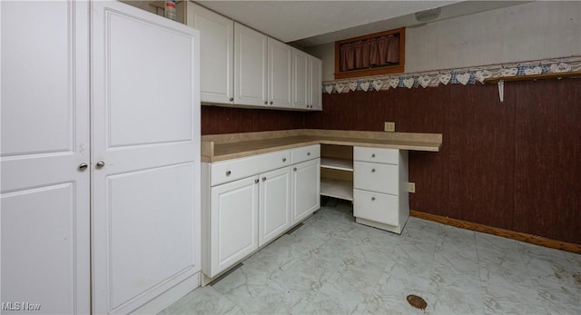 5286 Egypt Rd, Smithville, OH 44677 - unfurnished office with light marble finish floors, built in study area, wood walls, and baseboards