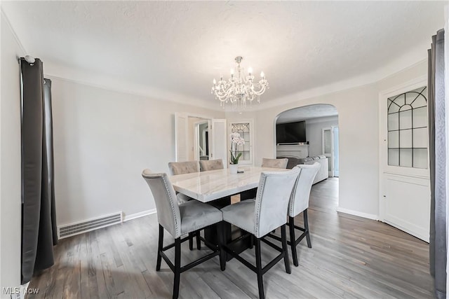 17314 Lomond Blvd, Shaker Heights, OH 44120 - dining area with arched walkways, a chandelier, and wood finished floors