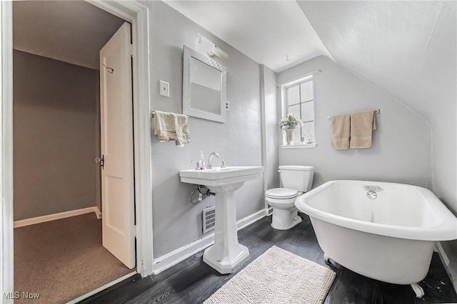 17314 Lomond Blvd, Shaker Heights, OH 44120 - bathroom featuring a freestanding tub, vaulted ceiling, and wood finished floors
