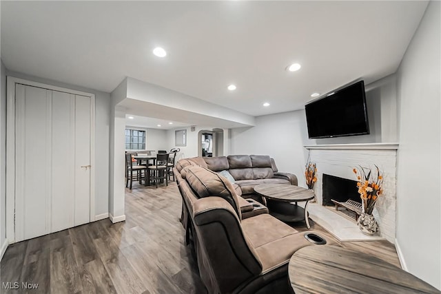 17314 Lomond Blvd, Shaker Heights, OH 44120 - living room featuring wood finished floors, a fireplace with raised hearth, and recessed lighting