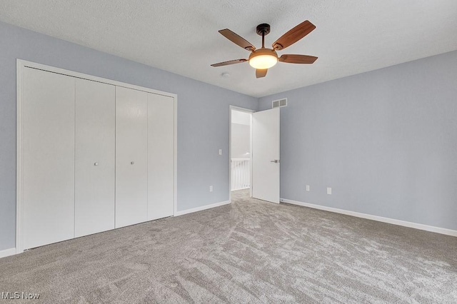 8000 Lake Rd, Seville, OH 44273 - unfurnished bedroom featuring carpet flooring, a closet, a textured ceiling, baseboards, and ceiling fan