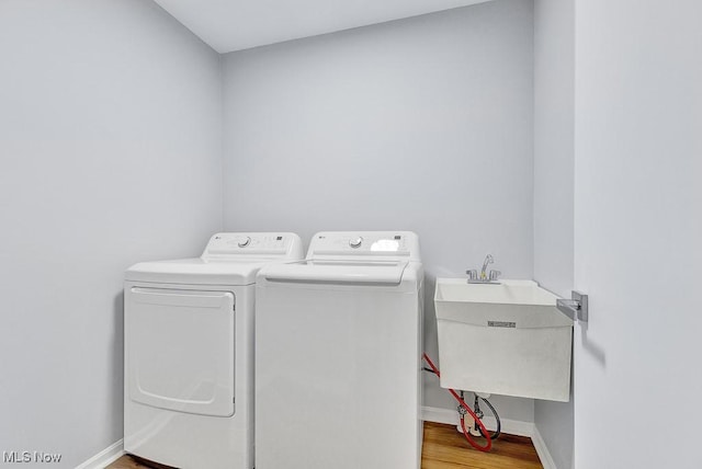 8000 Lake Rd, Seville, OH 44273 - washroom with washing machine and clothes dryer, wood finished floors, and baseboards