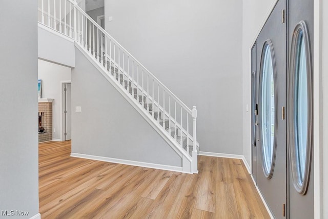 8000 Lake Rd, Seville, OH 44273 - entrance foyer with light wood finished floors, baseboards, a towering ceiling, and stairway