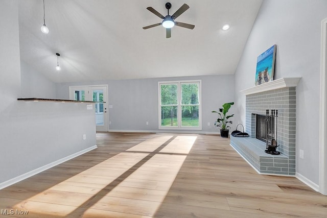 8000 Lake Rd, Seville, OH 44273 - unfurnished living room with a brick fireplace, a ceiling fan, wood finished floors, baseboards, and high vaulted ceiling