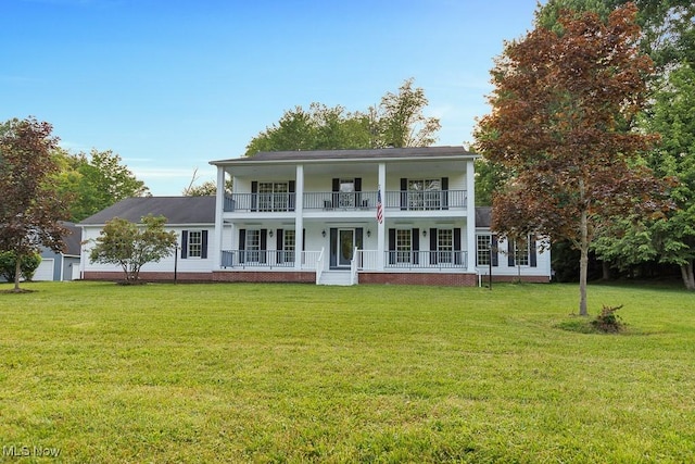 8000 Lake Rd, Seville, OH 44273 - greek revival house featuring a porch, a balcony, and a front yard