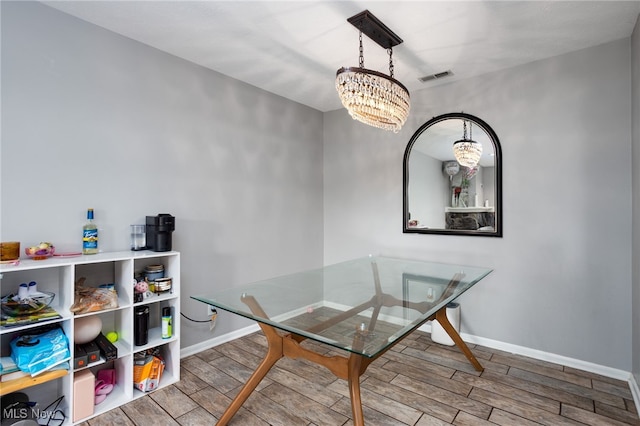 28140 Detroit Rd Unit D3, Westlake, OH 44145 - dining area featuring a chandelier, wood tiled floors, and baseboards