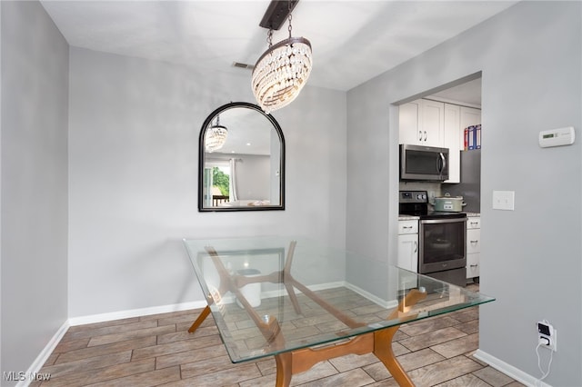 28140 Detroit Rd Unit D3, Westlake, OH 44145 - unfurnished dining area with a chandelier, wood tiled floors, and baseboards