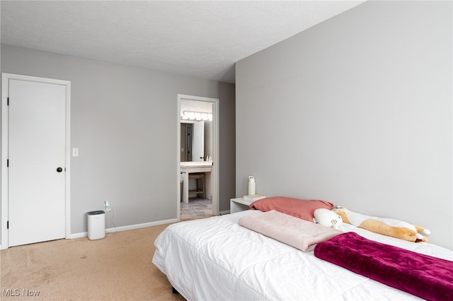 28140 Detroit Rd Unit D3, Westlake, OH 44145 - bedroom with carpet, ensuite bathroom, baseboards, and a textured ceiling