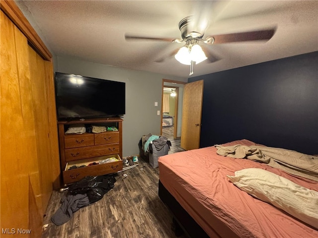 85 Arrow Rd NW, Carrollton, OH 44615 - bedroom with dark wood-type flooring, a ceiling fan, and a textured ceiling