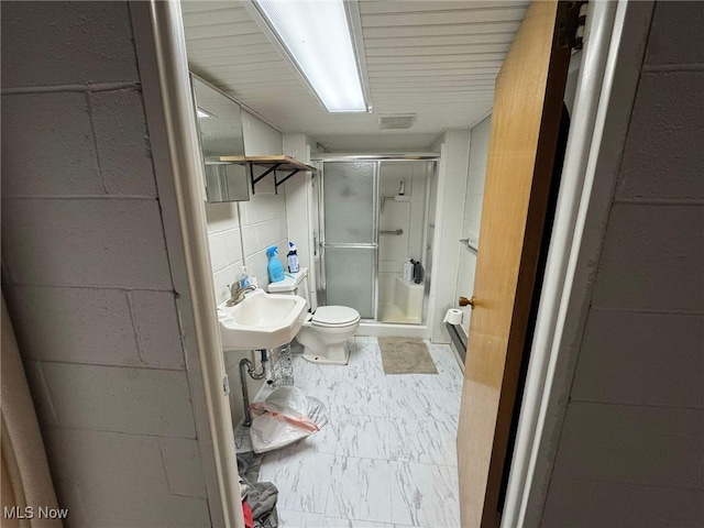 85 Arrow Rd NW, Carrollton, OH 44615 - bathroom featuring a stall shower, toilet, marble finish floors, and a sink