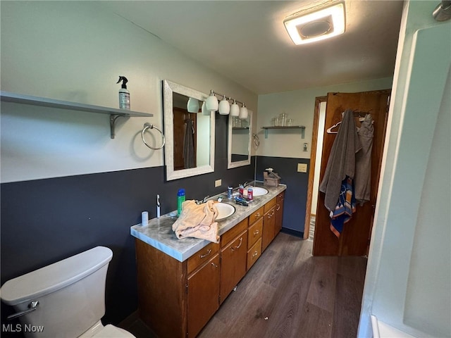 85 Arrow Rd NW, Carrollton, OH 44615 - full bathroom with wood finished floors, double vanity, and toilet