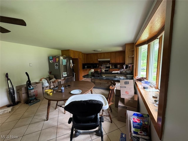 85 Arrow Rd NW, Carrollton, OH 44615 - kitchen featuring stainless steel appliances, dark countertops, brown cabinets, and light tile patterned floors