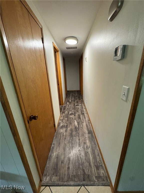 85 Arrow Rd NW, Carrollton, OH 44615 - corridor featuring wood finished floors