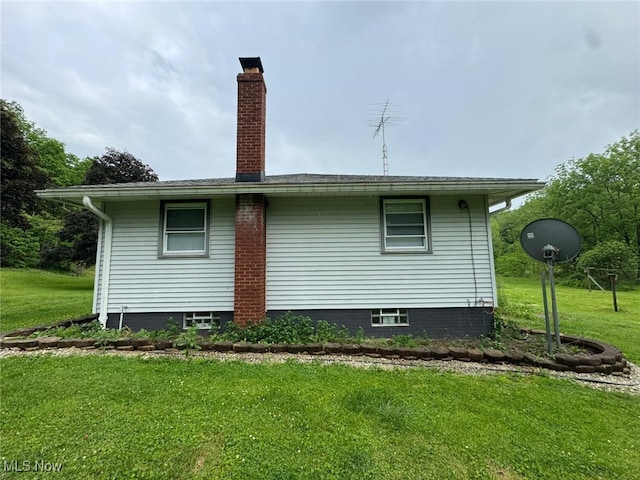 85 Arrow Rd NW, Carrollton, OH 44615 - view of property exterior featuring a lawn and a chimney