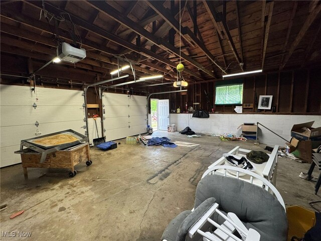 85 Arrow Rd NW, Carrollton, OH 44615 - garage with a garage door opener and concrete block wall