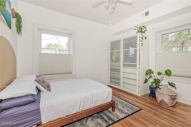 2725 Hampshire Rd Unit 2, Cleveland Heights, OH 44106 - bedroom featuring multiple windows, wood finished floors, a ceiling fan, and access to exterior