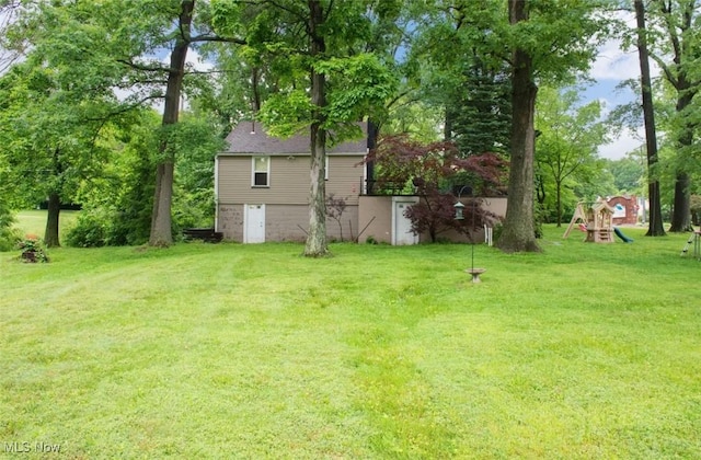 166 N Turner Rd, Youngstown, OH 44515 - view of green lawn with a playground and view of scattered trees