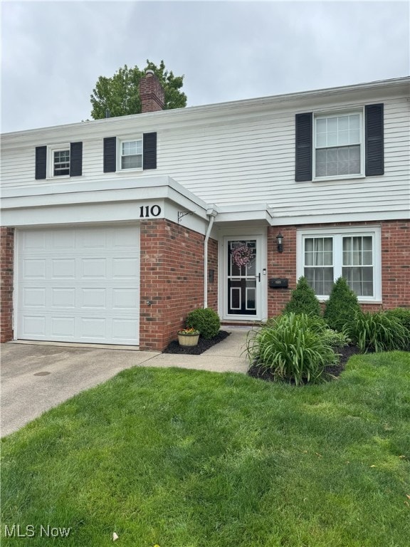 110 Gaslight Ln, Mayfield Heights, OH 44124 - view of front facade with brick siding, an attached garage, a front yard, a chimney, and concrete driveway
