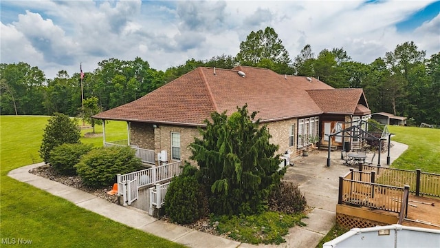 471 Buck Run, Pennsboro, WV 26415 - view of side of home with a lawn, brick siding, a wooden deck, and a patio