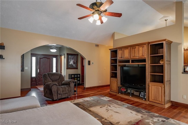 471 Buck Run, Pennsboro, WV 26415 - living room featuring arched walkways, a ceiling fan, wood finished floors, baseboards, and vaulted ceiling