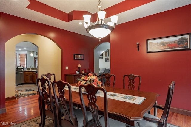 471 Buck Run, Pennsboro, WV 26415 - dining space with arched walkways, wood finished floors, a chandelier, and baseboards