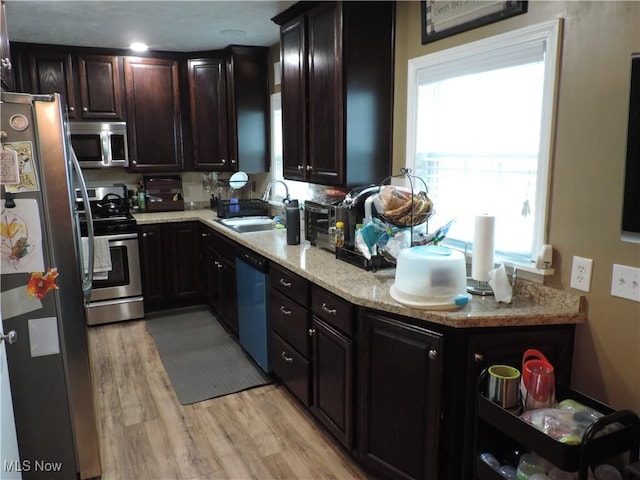 14610 Onaway Rd, Shaker Heights, OH 44120 - kitchen featuring stainless steel appliances, light wood-style floors, plenty of natural light, and dark brown cabinets