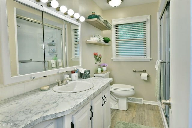 543 Towson Dr NW, Warren, OH 44483 - bathroom with a stall shower, vanity, wood finished floors, toilet, and baseboards