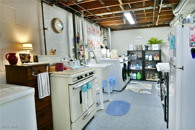 543 Towson Dr NW, Warren, OH 44483 - washroom with washing machine and clothes dryer and concrete block wall
