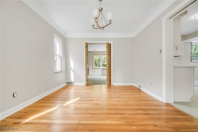 1540 S Belvoir Blvd, South Euclid, OH 44121 - unfurnished dining area with a chandelier, light wood-type flooring, and baseboards