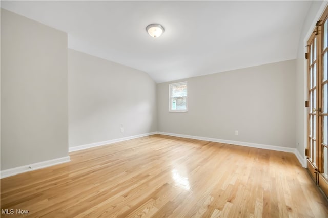 1540 S Belvoir Blvd, South Euclid, OH 44121 - unfurnished room featuring lofted ceiling, light wood-style floors, and baseboards
