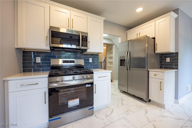 17607 Scottsdale Blvd, Shaker Heights, OH 44120 - kitchen featuring stainless steel appliances, light countertops, recessed lighting, white cabinetry, and light marble finish floors