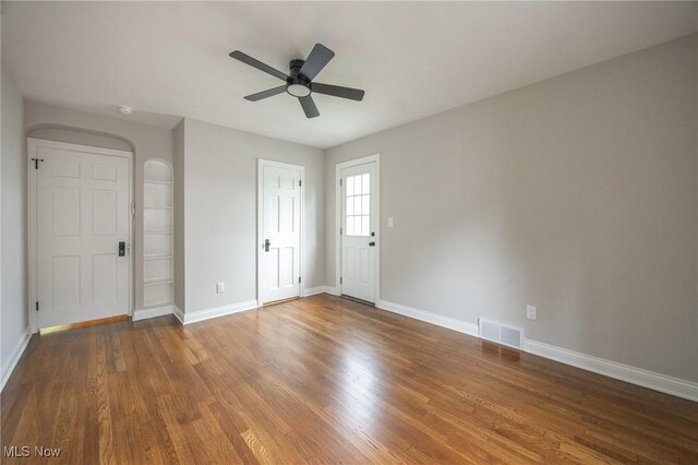 17607 Scottsdale Blvd, Shaker Heights, OH 44120 - spare room featuring a ceiling fan, arched walkways, wood finished floors, and baseboards