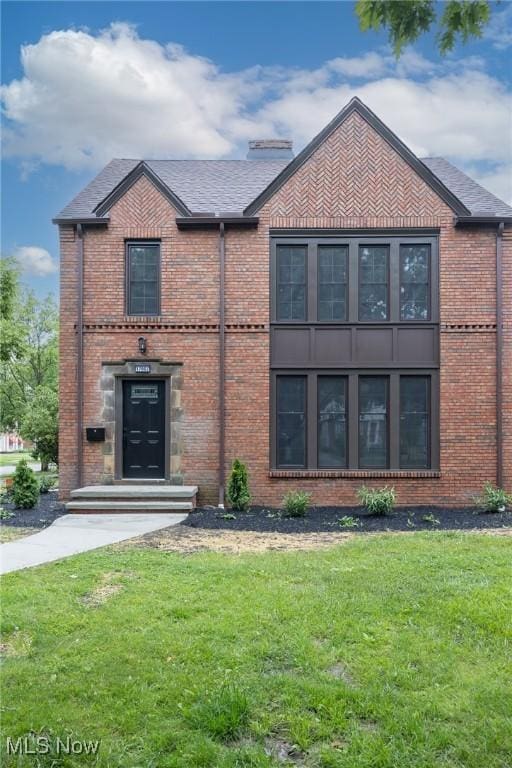 17607 Scottsdale Blvd, Shaker Heights, OH 44120 - view of front of property with brick siding, a front lawn, and a chimney