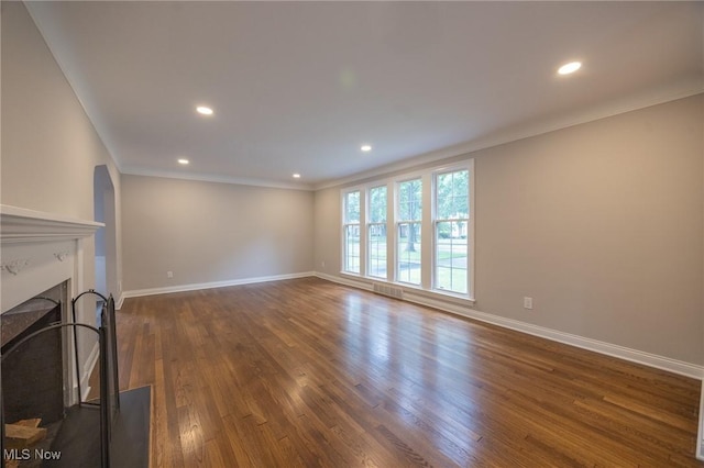 17607 Scottsdale Blvd, Shaker Heights, OH 44120 - unfurnished living room featuring ornamental molding, dark wood-type flooring, a fireplace, recessed lighting, and baseboards