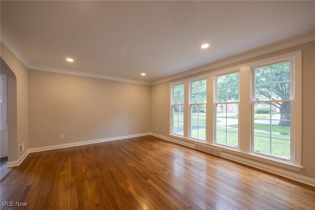 17607 Scottsdale Blvd, Shaker Heights, OH 44120 - unfurnished room featuring wood finished floors, crown molding, baseboards, recessed lighting, and arched walkways