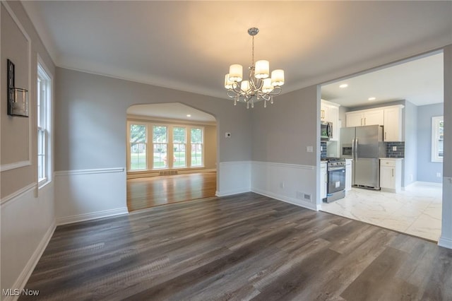 17607 Scottsdale Blvd, Shaker Heights, OH 44120 - empty room with arched walkways, a chandelier, recessed lighting, wood finished floors, and baseboards