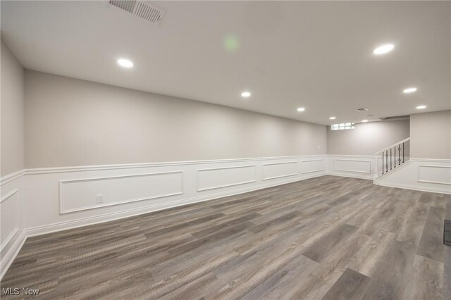 17607 Scottsdale Blvd, Shaker Heights, OH 44120 - spare room featuring a decorative wall, recessed lighting, wainscoting, wood finished floors, and stairway