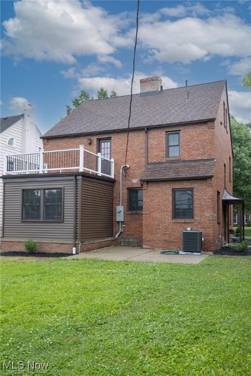 17607 Scottsdale Blvd, Shaker Heights, OH 44120 - back of house featuring brick siding, a patio area, a balcony, a chimney, and cooling unit