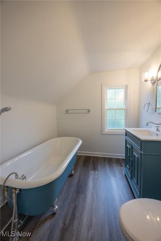 17607 Scottsdale Blvd, Shaker Heights, OH 44120 - full bath with vanity, a soaking tub, wood finished floors, lofted ceiling, and baseboards