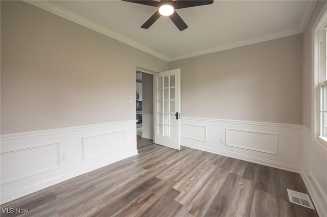 17607 Scottsdale Blvd, Shaker Heights, OH 44120 - empty room featuring ceiling fan, wood finished floors, wainscoting, crown molding, and french doors