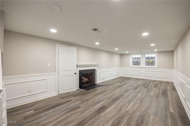 17607 Scottsdale Blvd, Shaker Heights, OH 44120 - unfurnished living room with a decorative wall, wainscoting, a fireplace with flush hearth, wood finished floors, and recessed lighting
