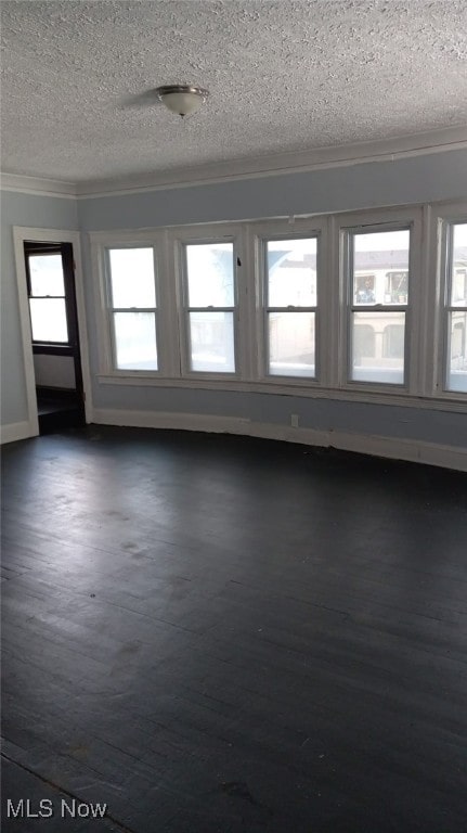 11705 Fairport Ave, Cleveland, OH 44108 - unfurnished room featuring crown molding, a textured ceiling, dark wood-style flooring, and baseboards