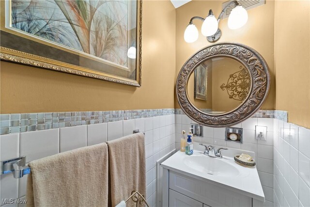 18975 Van Aken Blvd Unit 401, Shaker Heights, OH 44122 - bathroom with vanity, a wainscoted wall, and tile walls