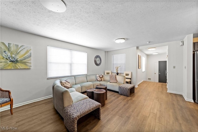 18975 Van Aken Blvd Unit 401, Shaker Heights, OH 44122 - living area with wood finished floors, baseboards, and a textured ceiling