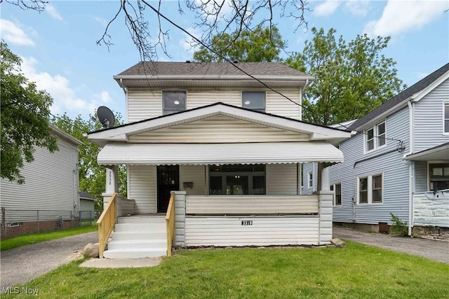3338 E 130th St, Cleveland, OH 44120 - traditional style home with a porch, a front lawn, a shingled roof, and driveway