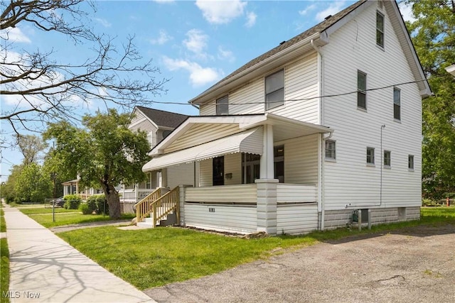 3338 E 130th St, Cleveland, OH 44120 - view of side of home featuring a porch and a lawn
